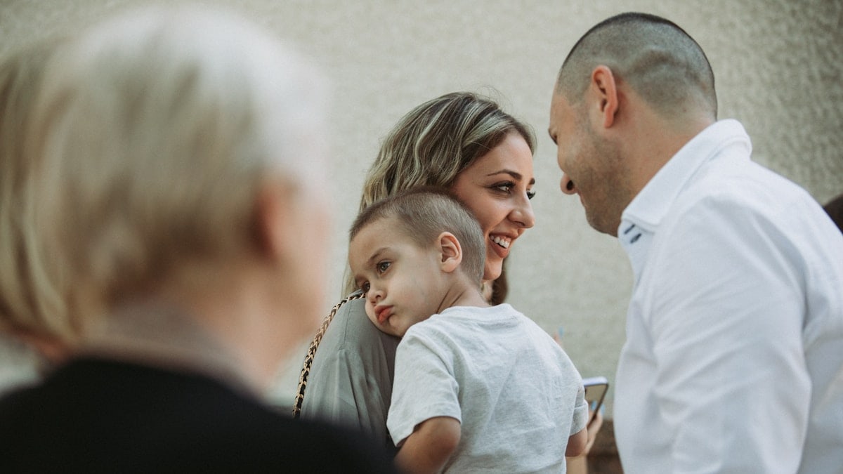 a woman and a man with a small child